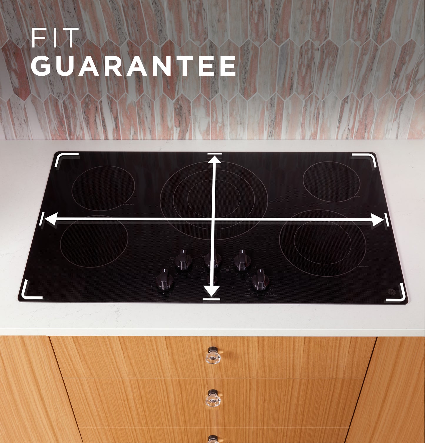 Black smooth electric cooktop with five burners and knob controls installed on white kitchen countertop