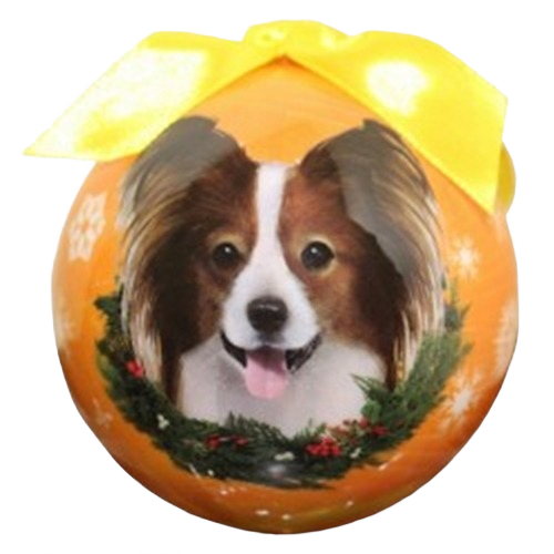 Round orange Christmas ornament featuring a Papillon dog face with festive wreath and yellow ribbon topper