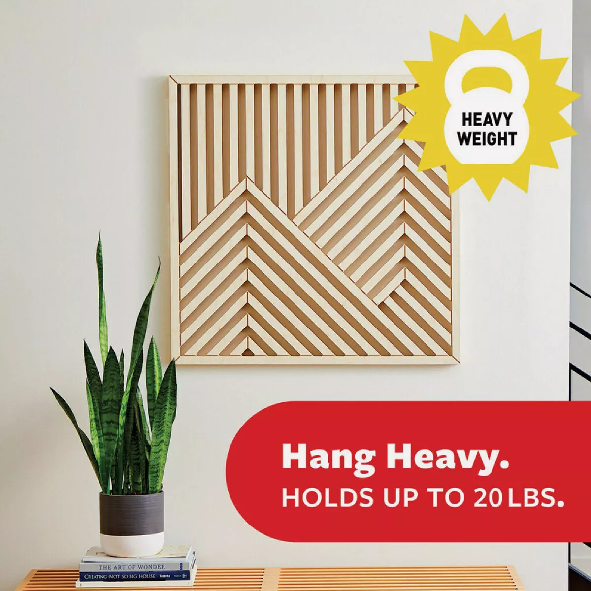 Decorative wood wall art secured above bench with snake plant and books in modern home improvement setting