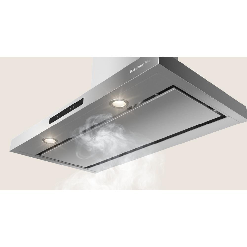 Stainless steel wall-mounted canopy hood with built-in lights and digital controls in kitchen appliances collection