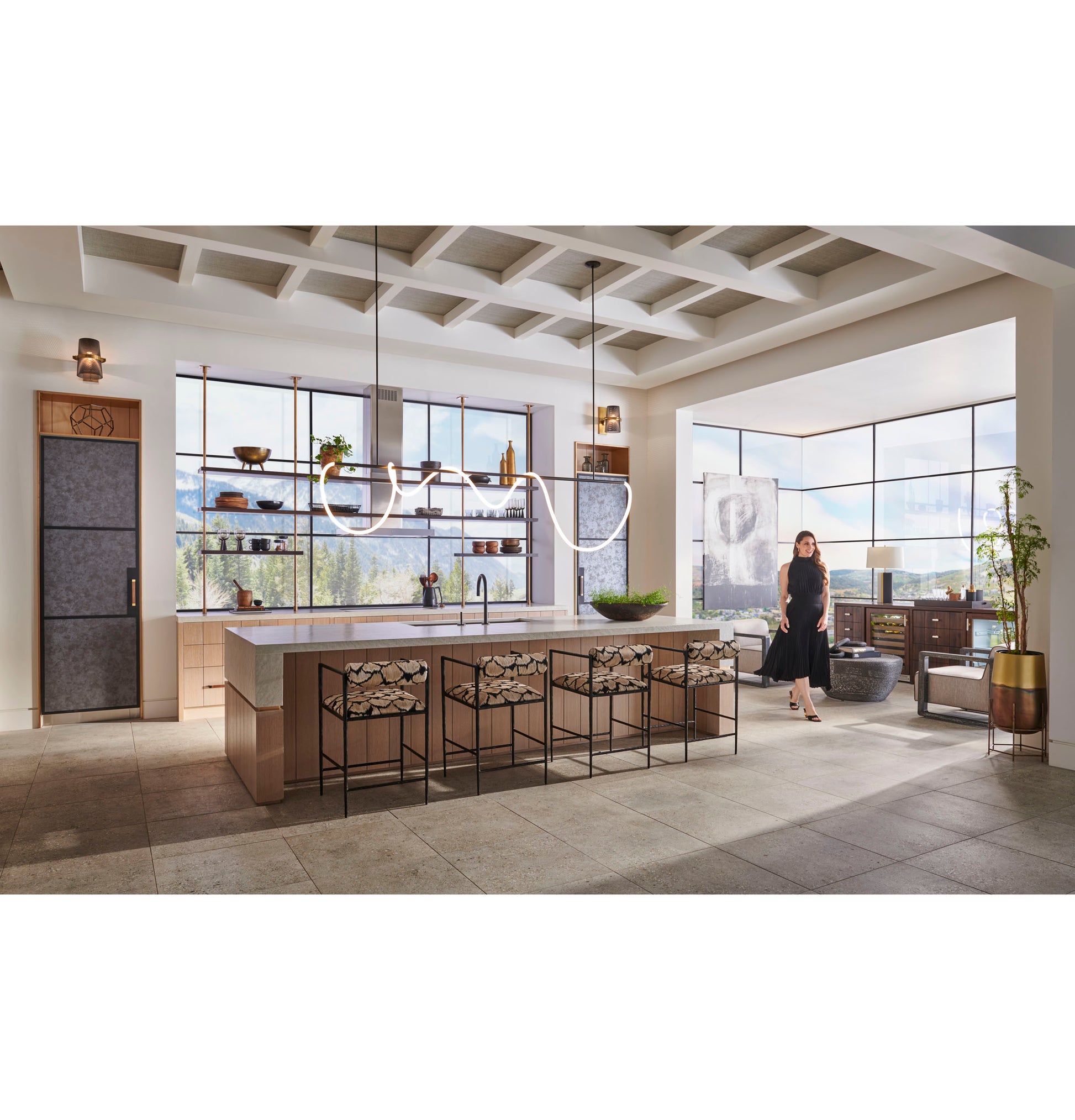 Spacious contemporary kitchen with minimalist double wall oven, large island with patterned stools, and panoramic window views