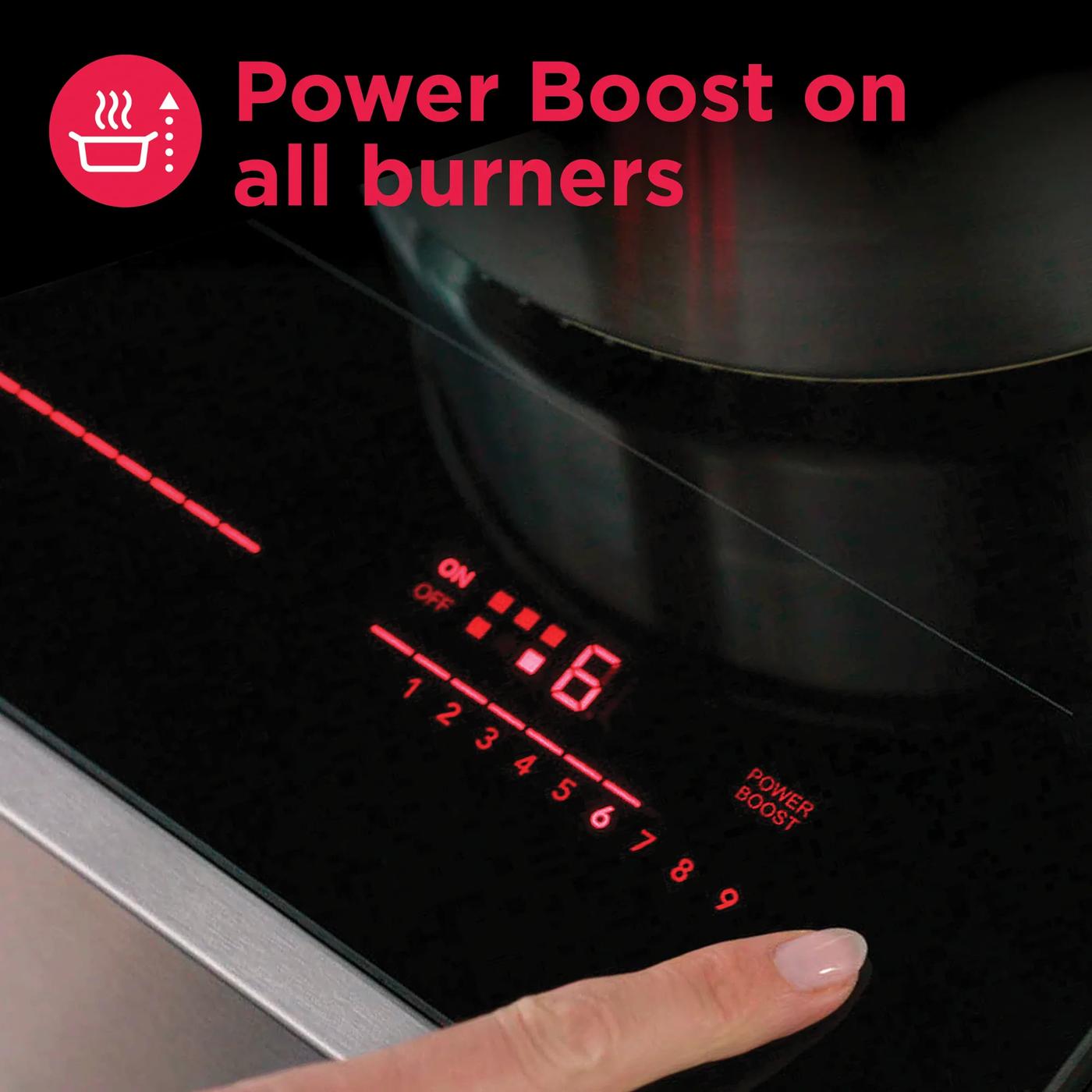 Close-up of black induction cooktop control panel with red digital display and finger activating power boost feature