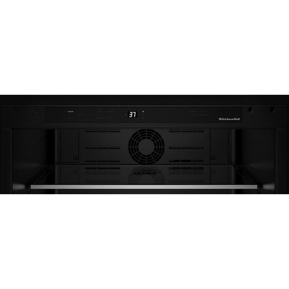 Interior view of black KitchenAid appliance with digital timer and fan for even cooking in modern kitchen setup