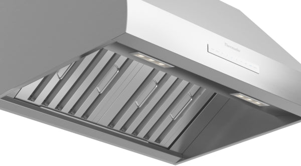 Sleek stainless steel wall-mounted range hood with built-in lights and durable baffle filters from Thermador Appliances collection