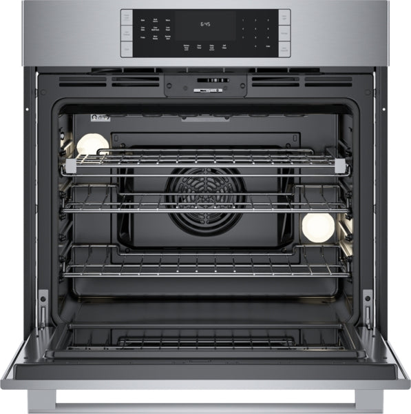 Open stainless steel oven interior with multiple adjustable racks and convection fan from Bosch wall oven collection