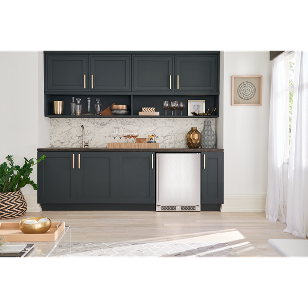 Modern kitchen with dark cabinetry, marble backsplash, and built-in stainless steel beverage center from Appliances collection