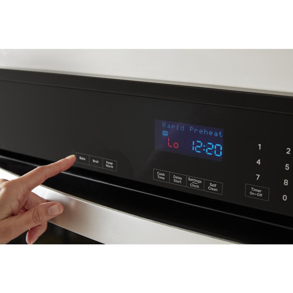 Close-up of a digital control panel with blue LED display showing rapid preheat on a stainless steel double wall oven