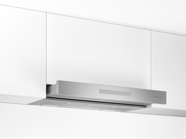 Stainless steel custom insert hood installed under white kitchen cabinets from range hoods collection