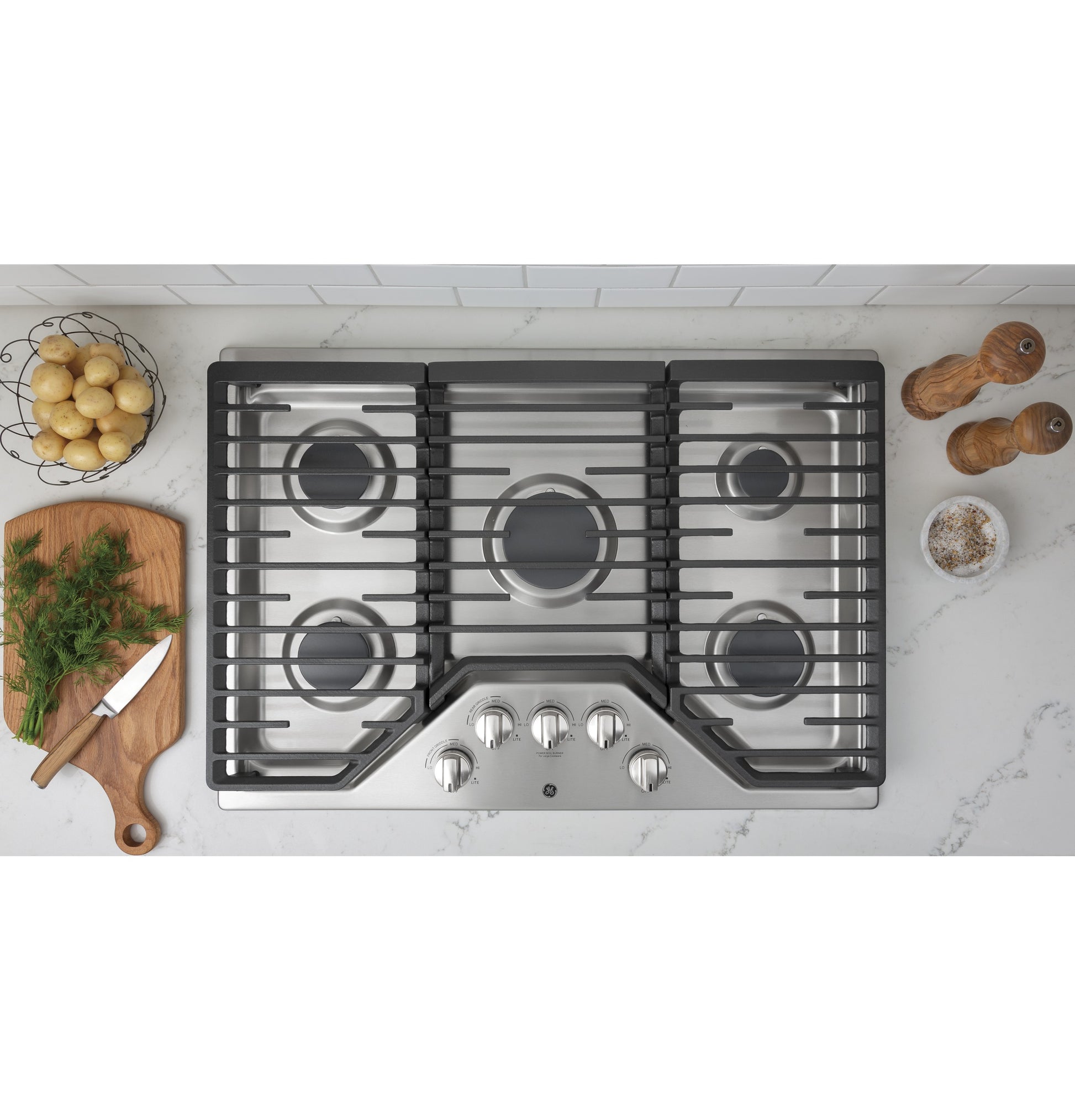 Built-in stainless steel gas cooktop with five burners and dishwasher safe grates from kitchen appliances collection