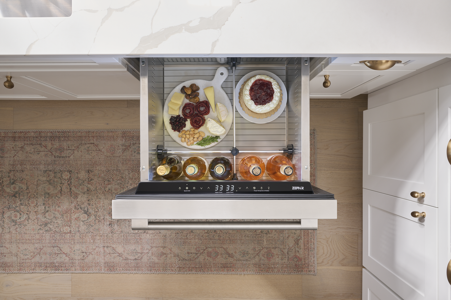 Under-counter stainless steel dual zone refrigerator drawer open with snacks and drinks in kitchen appliances collection
