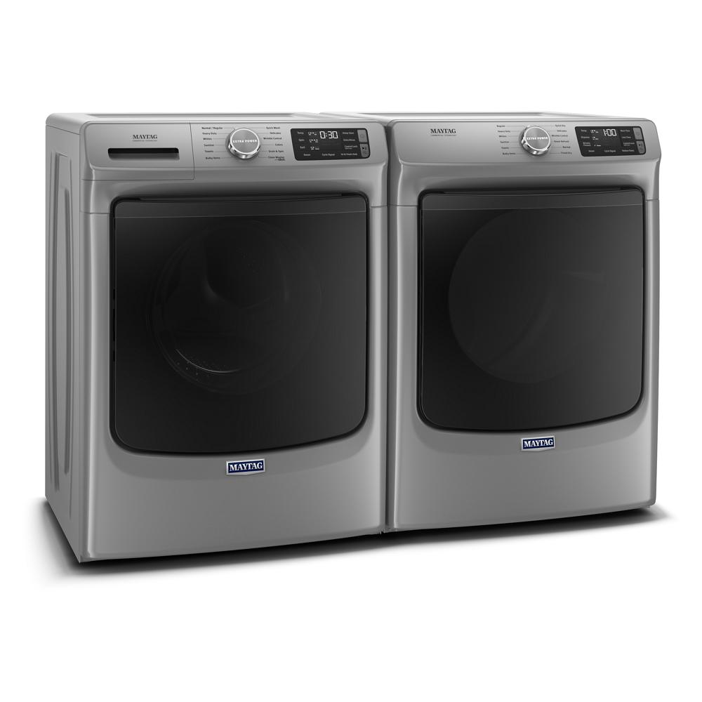 Silver front load washer and matching dryer with digital display and control knobs in Washers & Dryers collection