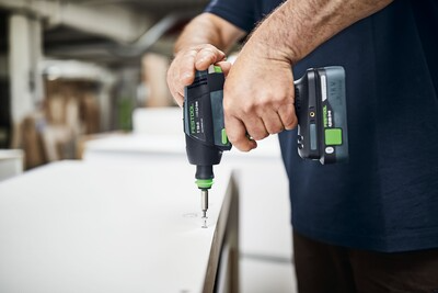 Person using Festool cordless drill with Li-Ion battery on wood surface in woodworking power tools collection