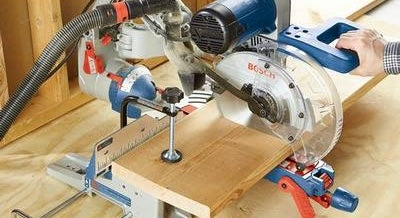 Bosch 10 in. dual-bevel glide miter saw cutting wood on workbench, part of power tools and saws collections