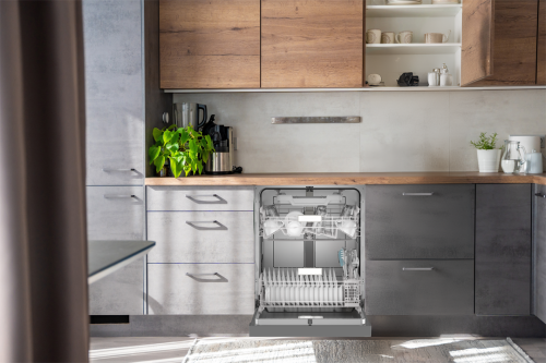 Modern kitchen setup with open dishwasher showcasing clean white dishes and utensils in stainless steel racks