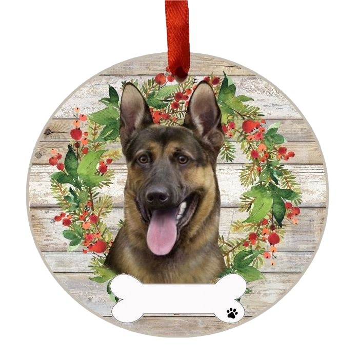 Round wooden Christmas ornament featuring a German Shepherd’s face framed by festive green and red wreath with berries