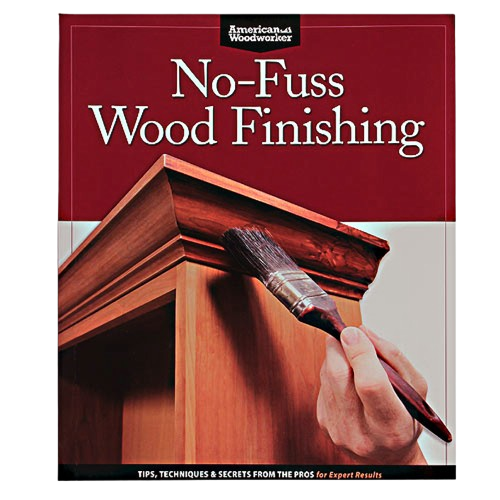 Hand applying wood finish with brush on detailed wooden furniture, demonstrating wood finishing techniques guide