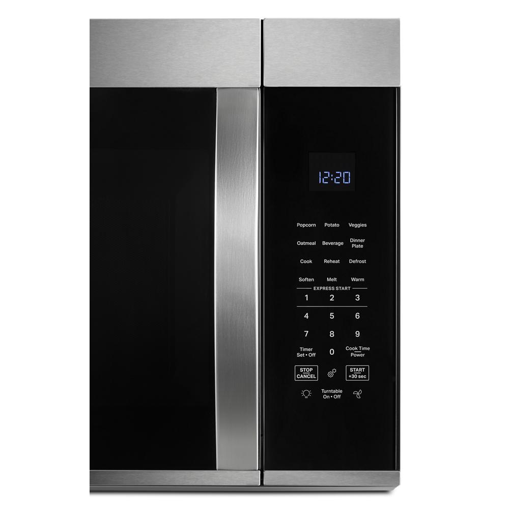Stainless steel microwave control panel with digital clock and sensor cooking preset buttons in kitchen appliances collection