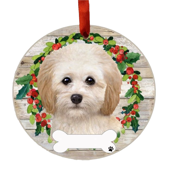 Round Christmas ornament featuring a Cockapoo face framed by a festive holly wreath and hanging red ribbon