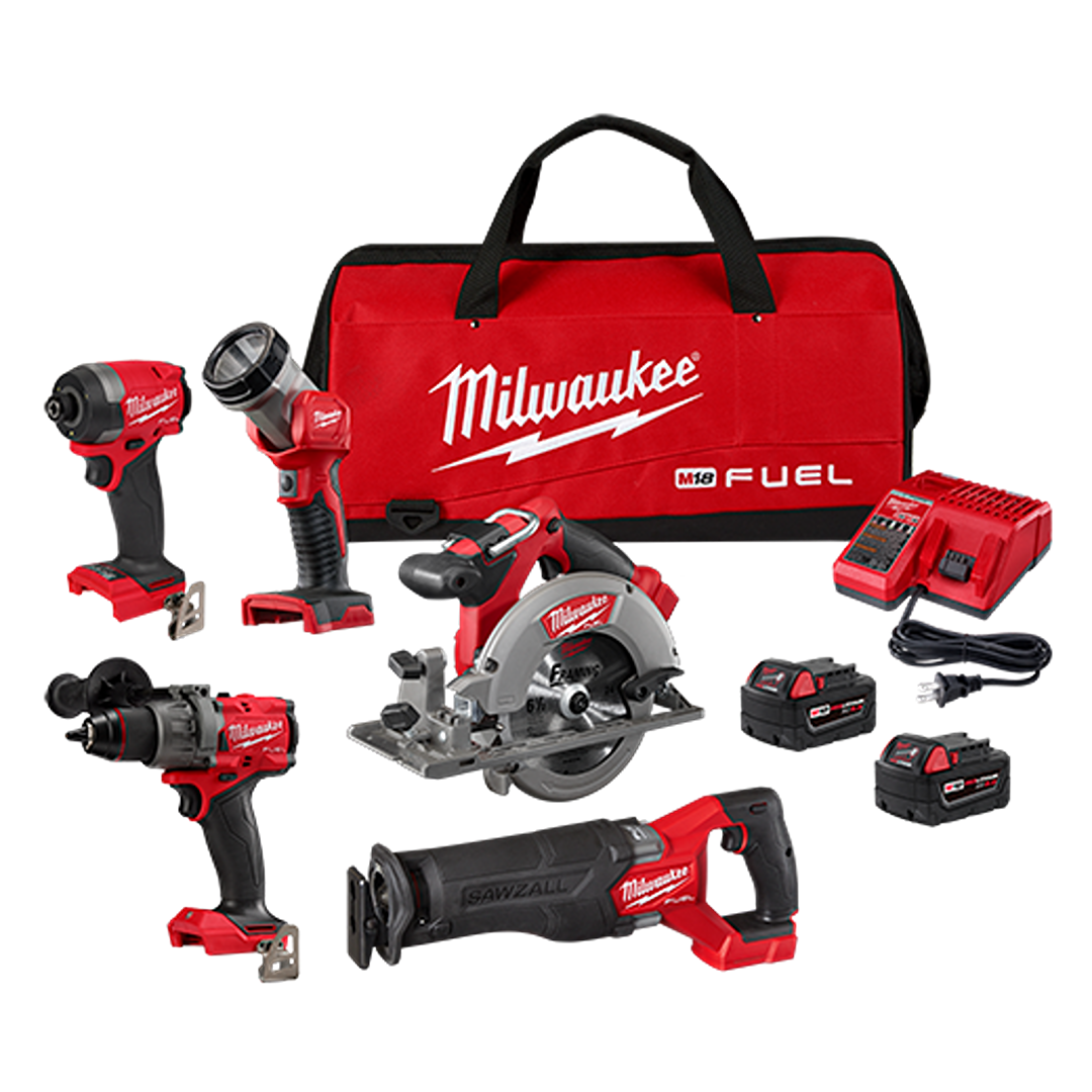 Set of cordless power tools including drill, circular saw, reciprocating saw, flashlight, two batteries, charger, and red carrying bag
