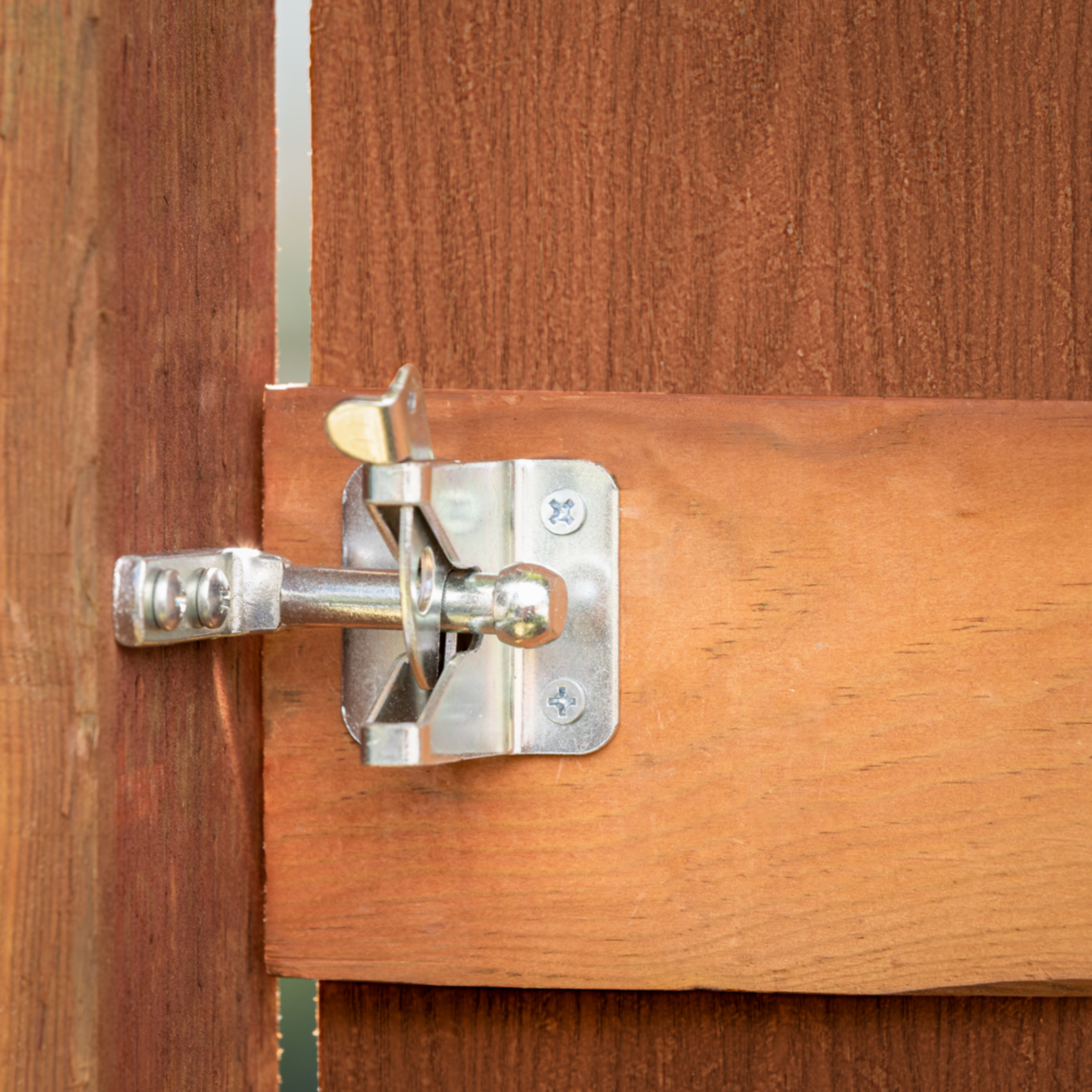 Zinc-plated automatic gate latch with steel rod installed on wooden gate for home improvement and gate hardware projects under $50