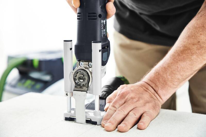 Person using a plunge base accessory with oscillating multi-tool for precise woodworking cuts in home improvement tools collection