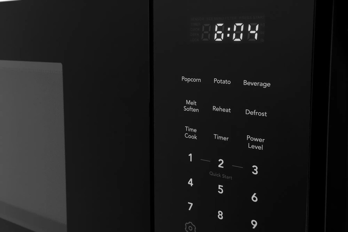 Close-up of black microwave control panel with digital clock and preset cooking options from Microwaves collection