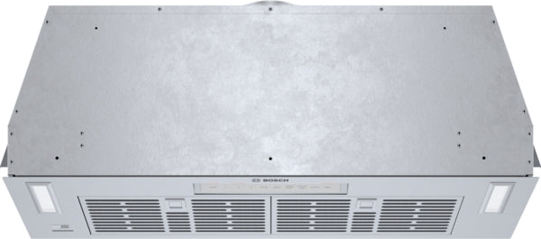 Stainless steel custom insert for over-the-range hood with Bosch branding and integrated lighting in kitchen appliances collection