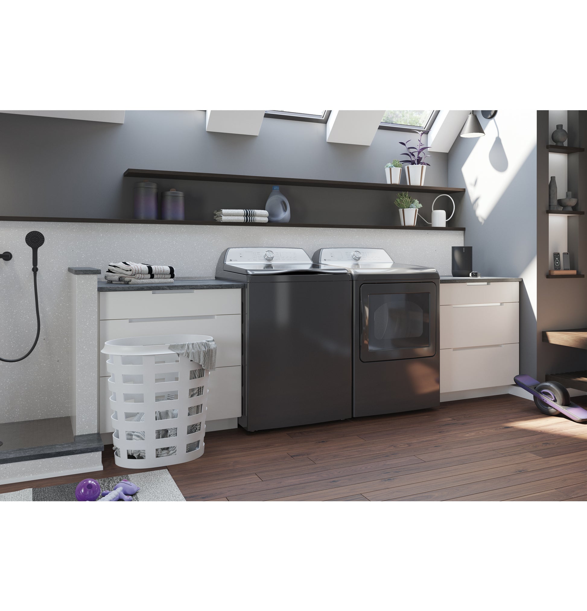 Modern laundry room with dark electric dryer and matching washer, white cabinets, and natural light from skylights in home appliances collection
