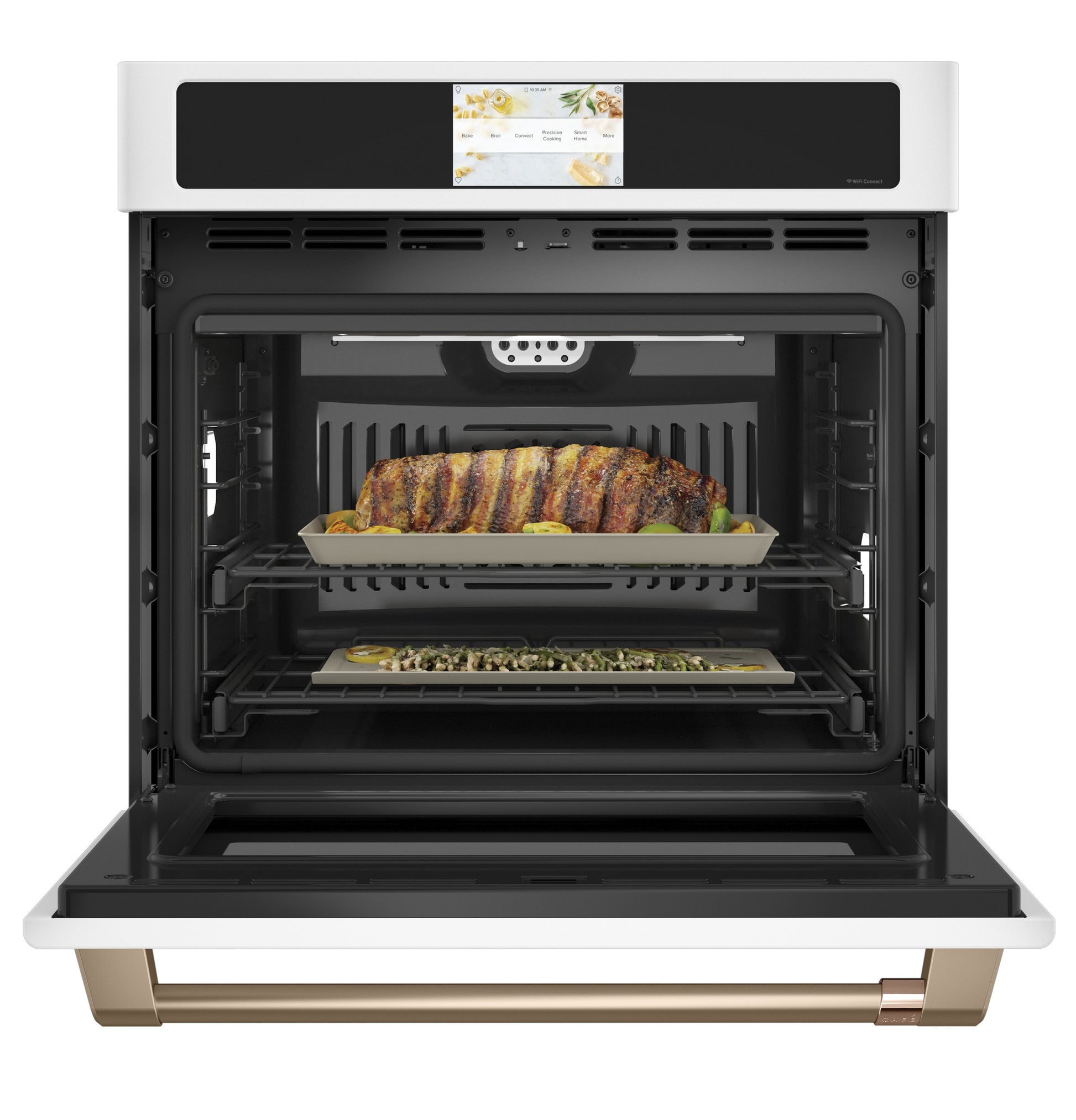 Open smart built-in convection oven in kitchen appliances with roast and vegetable dishes inside the single wall oven