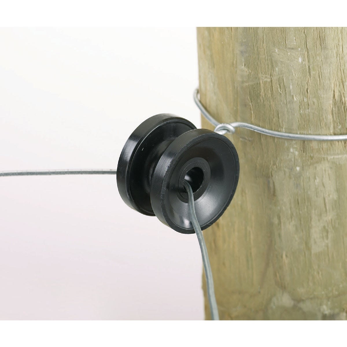 Black polymer insulator securing electric fence wire to a wooden post for tools and home improvement projects