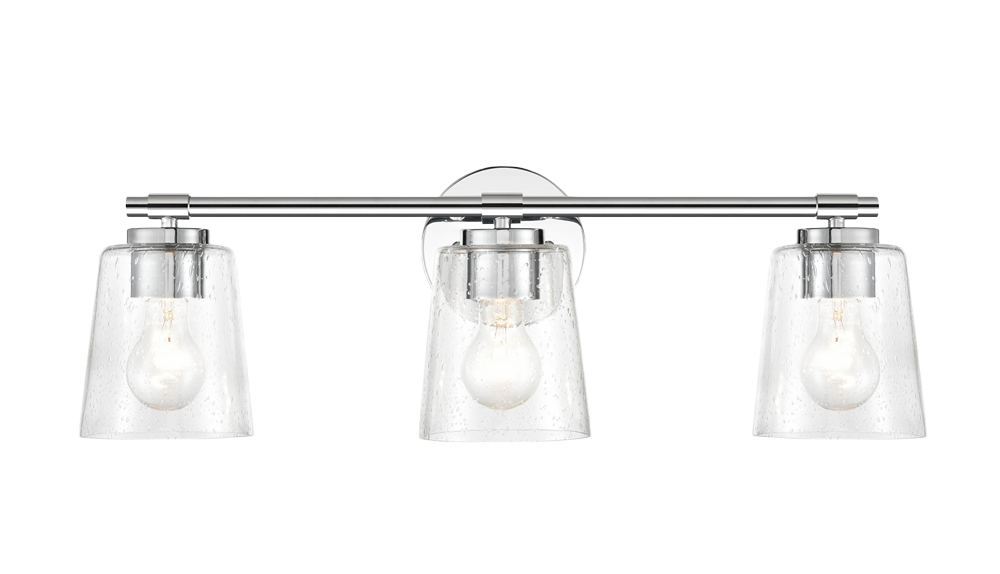 Three-light bathroom vanity fixture with polished chrome finish and clear seeded glass shades for wall lighting