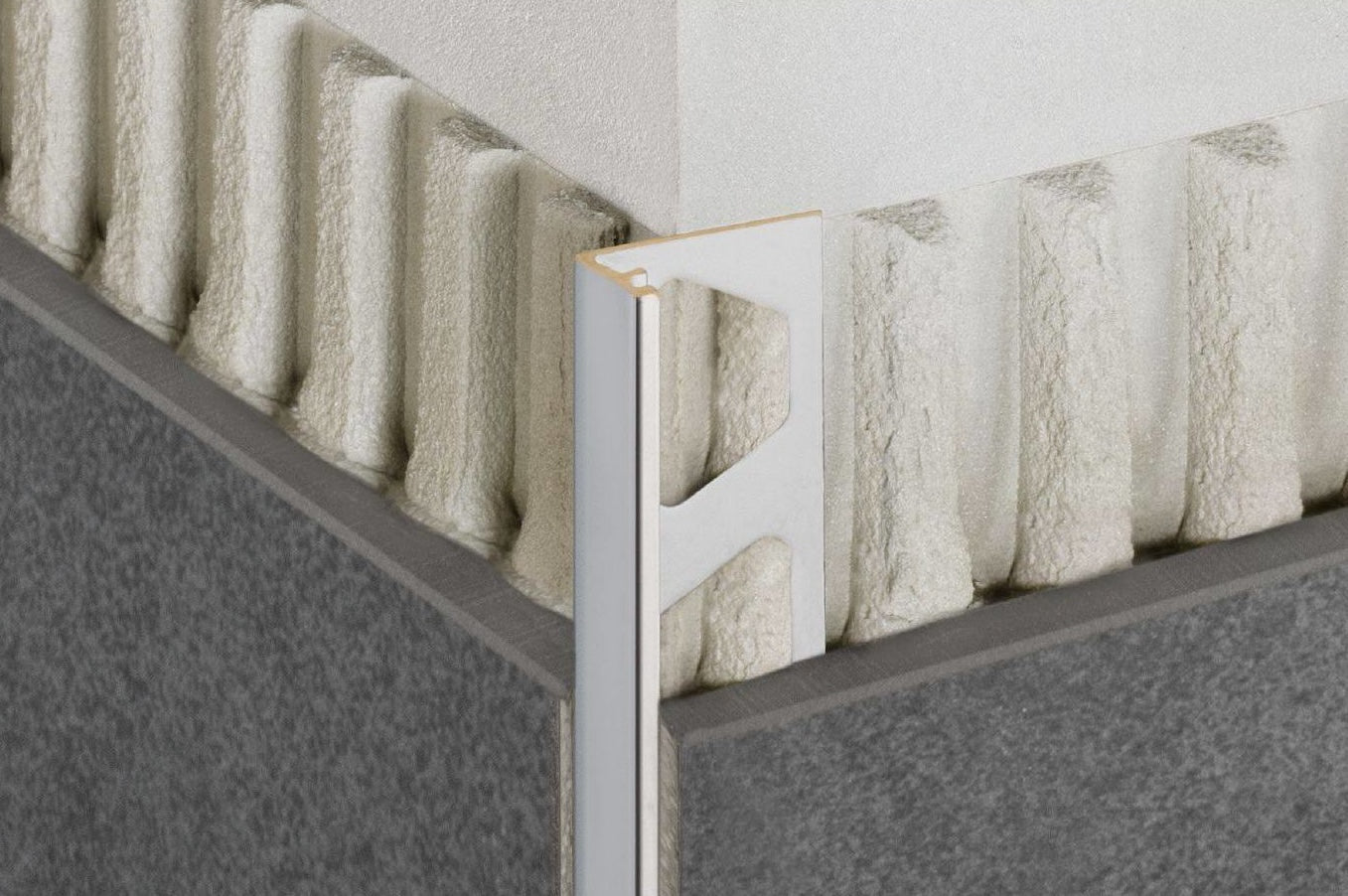 Greige edge trim profile installed on outside tile corner for flooring and home improvement projects