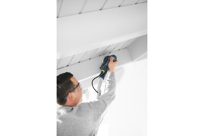Person using a corded random orbit sander on a white wooden ceiling beam for home improvement tasks