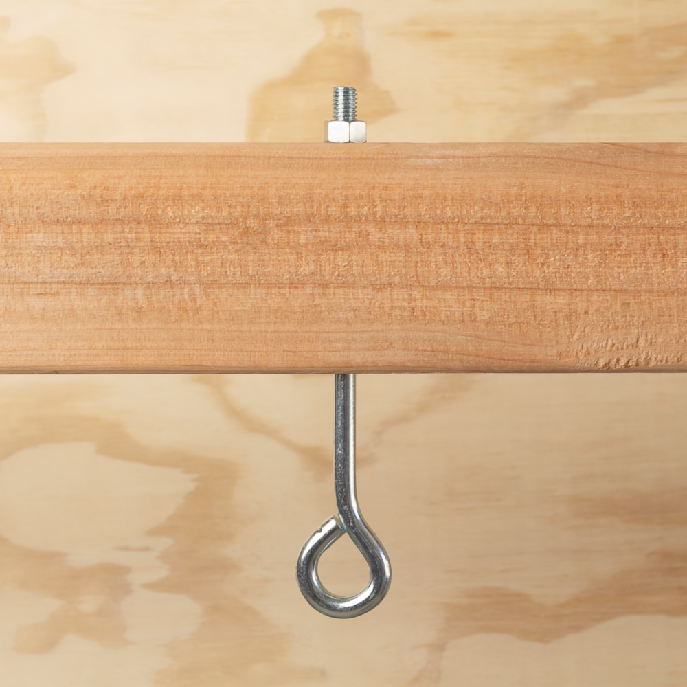 Zinc eye bolt with hex nut installed through wood for secure fastening in hardware and fasteners collections