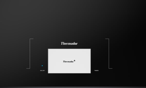 Close-up of dark gray Thermador induction cooktop control panel with digital display and power indicator light