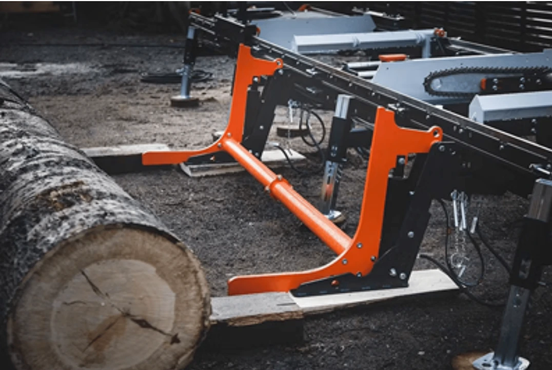 Industrial log loader arms with orange accents for lifting large logs in tool and power tool accessories collections