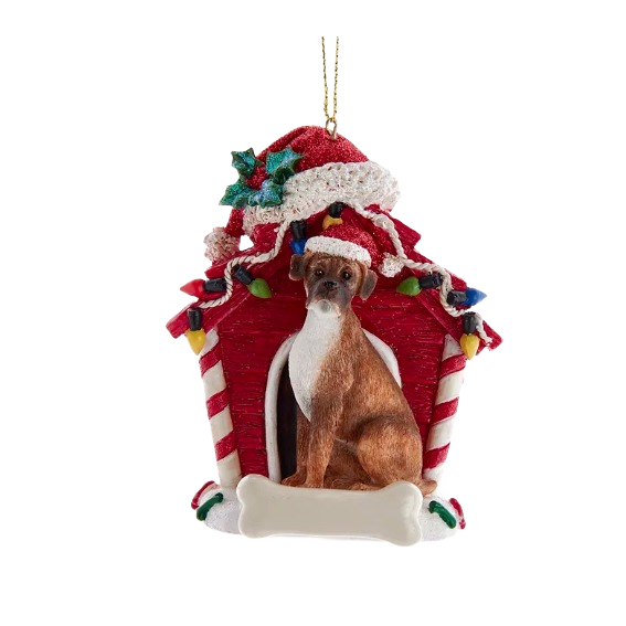 Boxer dog figurine wearing Santa hat sitting in front of red dog house ornament with holiday lights for Christmas decor