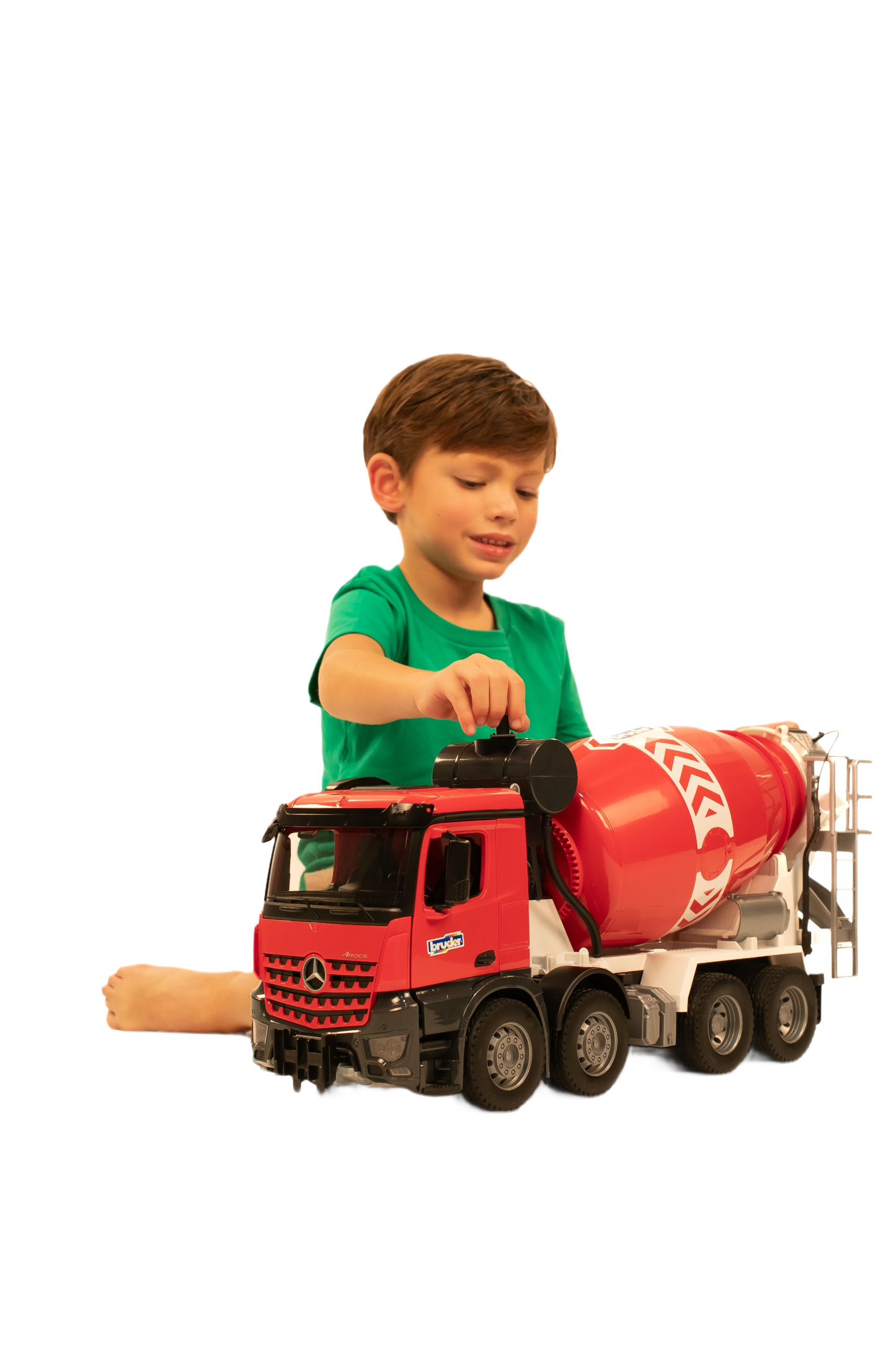 Young boy playing with a detailed red Bruder Arocs Cement Mixer toy truck for hands-on construction play