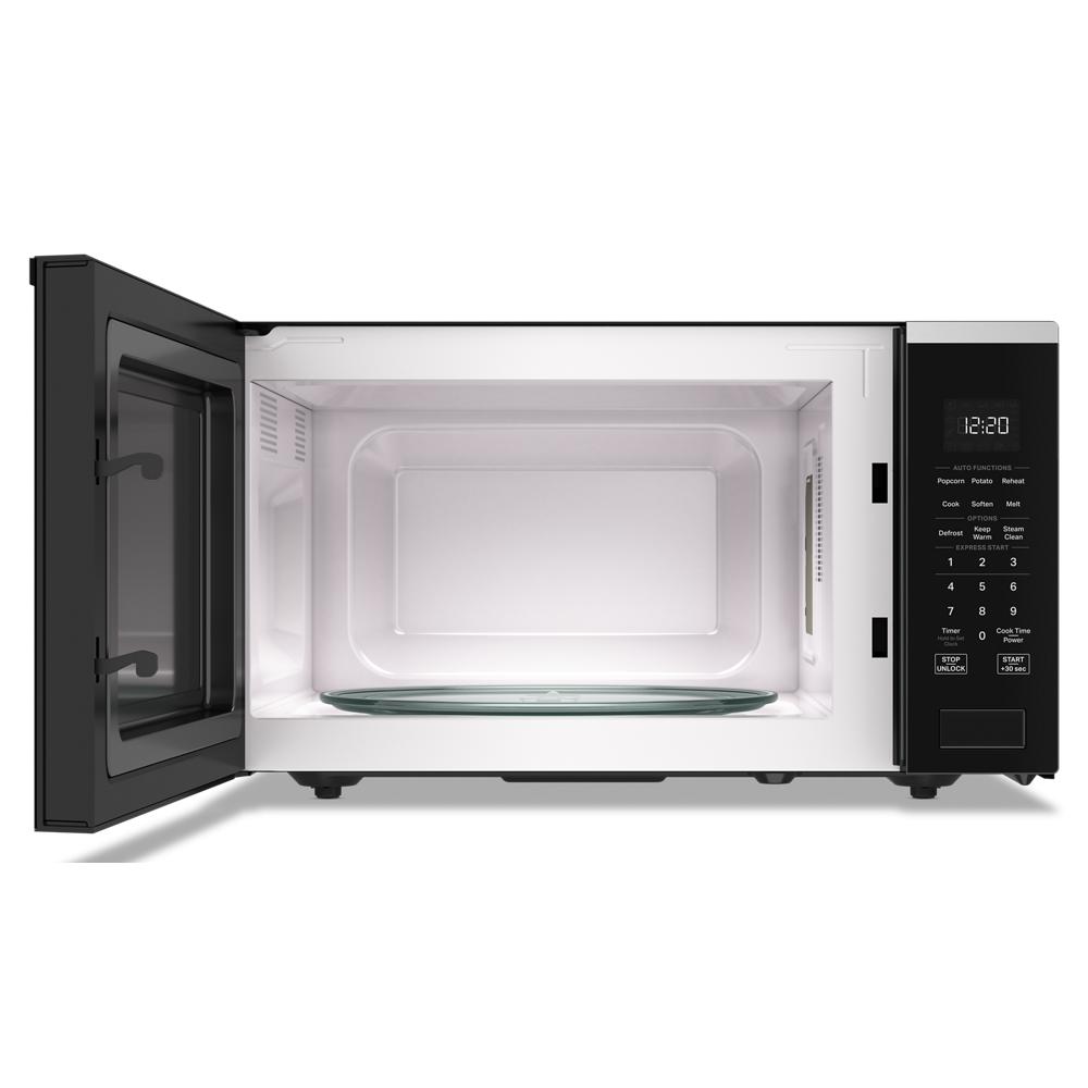 Open black Whirlpool sensor cooking microwave interior showing dishwasher-safe turntable and digital control panel in appliances collection