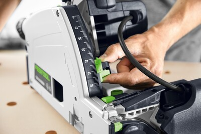 Hand adjusting angle guide on Festool plunge cut track saw for precise cuts in power tools and home improvement collection