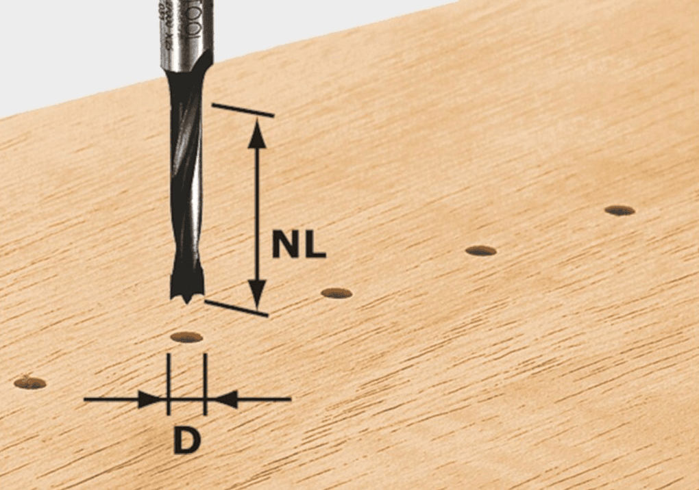 Close-up of brad point drill bit creating precision dowel holes on wood for woodworking tool accessories.