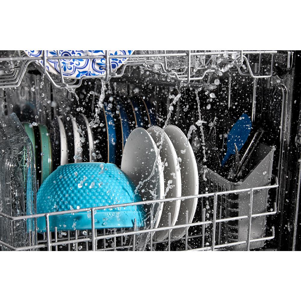 Close-up of blue and white dishes being cleaned with water sprays inside a front control dishwasher from kitchen appliances.