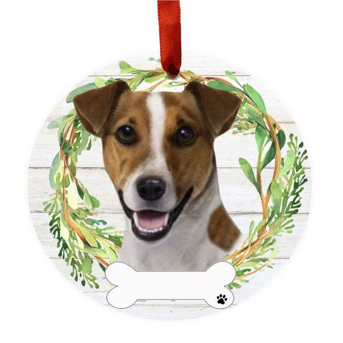 Round ornament featuring a smiling Jack Russell dog face inside a green leafy wreath with a red hanging ribbon