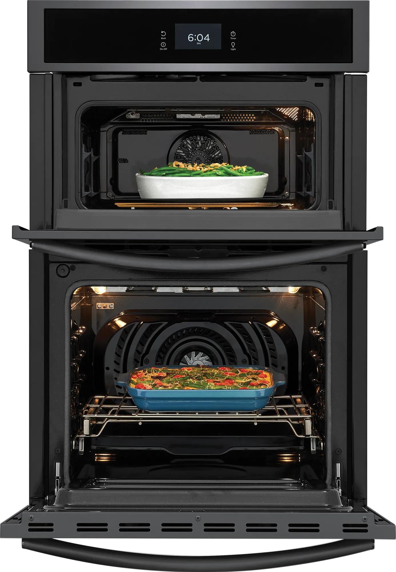Black electric wall oven and microwave combination with dishes inside from kitchen and appliances collections