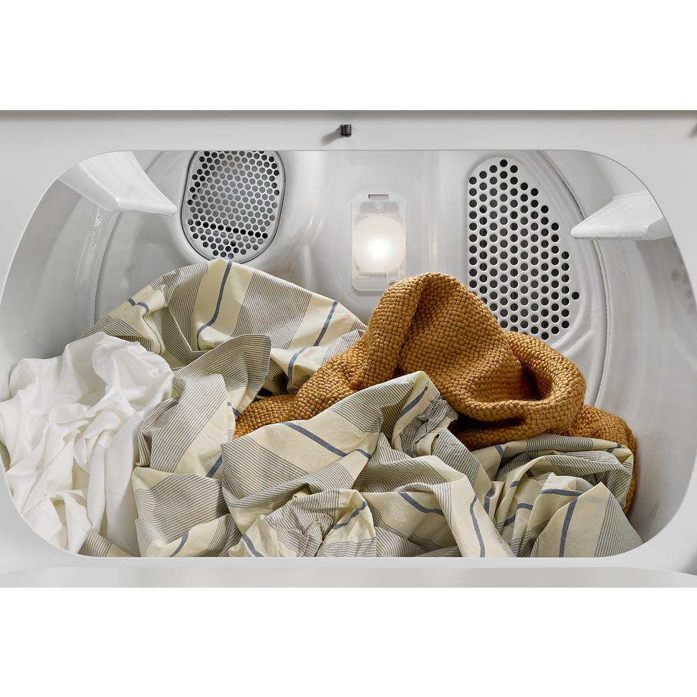 Inside view of white electric dryer drum with mixed laundry including a brown knit and striped fabrics from dryers collection