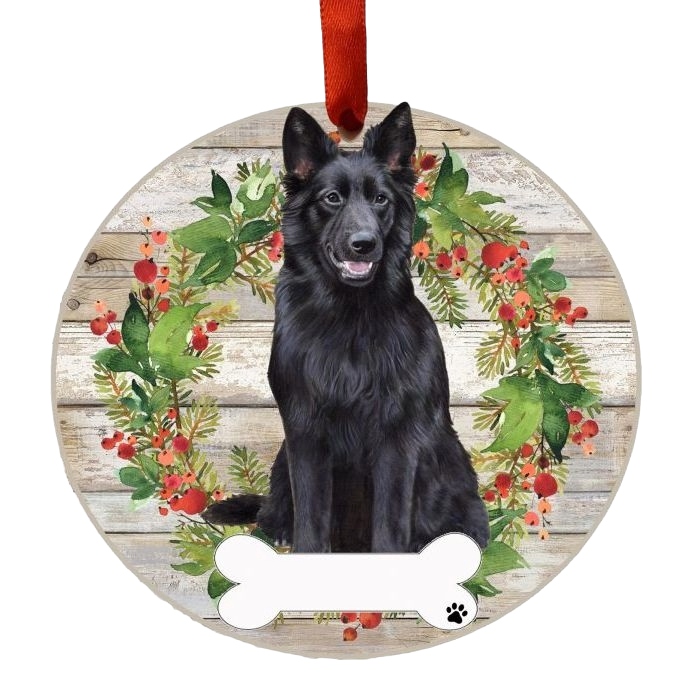 Round wooden Christmas ornament with a black German Shepherd and festive wreath and red ribbon hanger