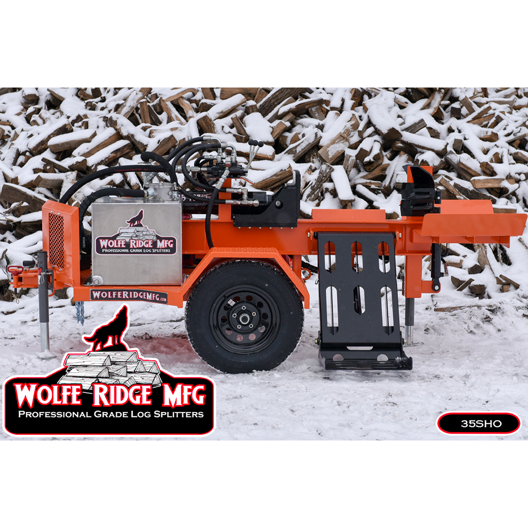 Orange Wolfe Ridge commercial log splitter with hydraulic system and wheels on snowy ground near firewood pile