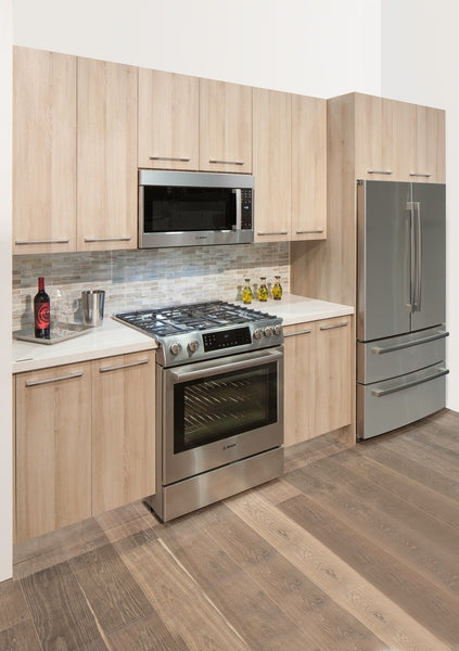 Kitchen setting with stainless steel gas range and built-in microwave from Bosch over the range microwaves collection