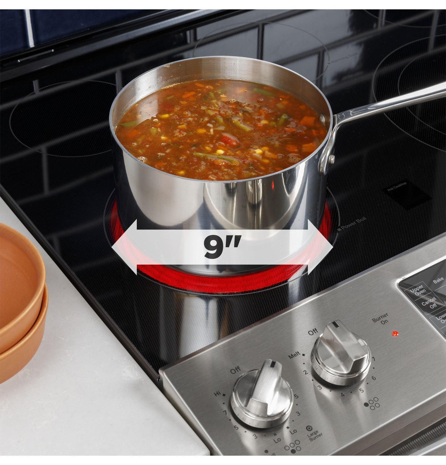 Stainless steel pot simmering vegetable soup on 9-inch burner of electric cooktop from ranges collection
