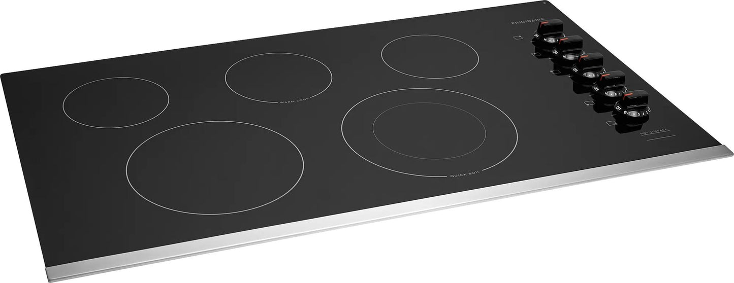 Black 36-inch electric cooktop with five heating elements and control knobs in kitchen and appliances collection